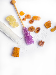 Various different types of sugar, in flask on white background
