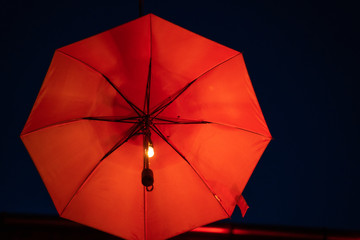 Flying red umbrella , part of inner courtyard decoration design, by night. With copy space
