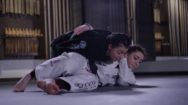 Women training in martial arts in a dojo