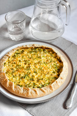 Tart with eggs and green onions on a plate