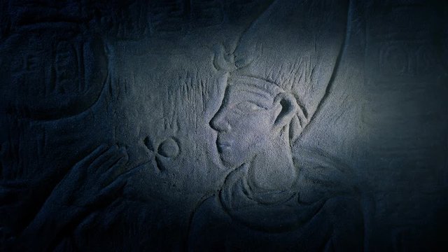 Egyptian Wall Art Lit Up In Dusty Tomb