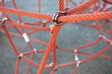 Red ropes connected by reef metal knot