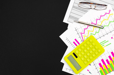Financial documents with calculator, pen and eyeglasses on black background. Top view. Space for text.
