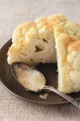 Boiled whole cauliflower covered with butter and breadcrumbs