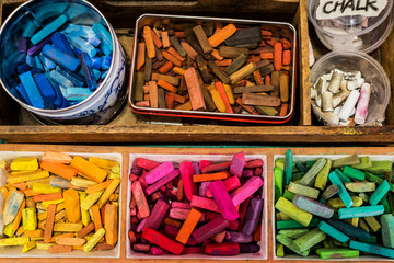 Overhead view of varieties of crayons in containers