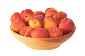 heap of fresh red apricots in wooden cup isolated on white background
