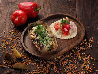 Meat and cheese with baked potatoes and fresh vegetables