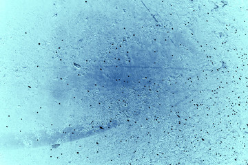 Vintage blue background. Rough painted wall of sapphire color. Imperfect plane of blue colored. Uneven old decorative toned backdrop of cyan tint. Texture of sapphirine hue. Ornamental stony surface.