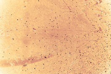 Vintage yellow background. Rough painted wall of aspen gold color. Imperfect plane of golden colored. Uneven old decorative toned backdrop of yellow tint. Texture of gold hue. Ornamental stony surface