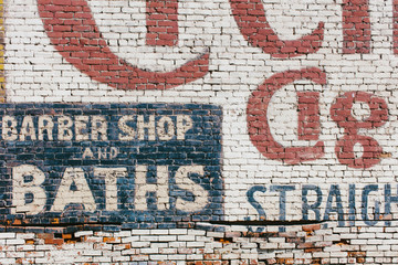 "Barber Shop & Baths" sign painted on old old brick wall,"Barber Shop & Baths" painted on old old brick wall