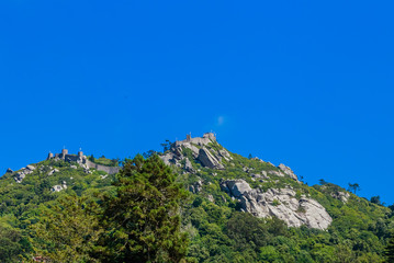 Fototapeta na wymiar The Castle of the Moors is a hilltop medieval castle in Sintra. View of the castle from Quinta da Regaleira.. Portugal