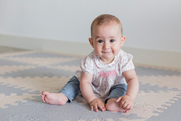portrait of a beautiful baby girl at home. Family concept indoors. Daytime and lifestyle