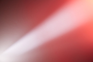 Light ray of light with a light pink spot transition on a dark purple and red