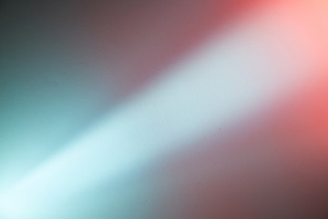 Light ray of light with the transition to a pink spot on a dark blue and dark pink background