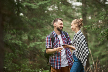 Couple with smart phone in the forest