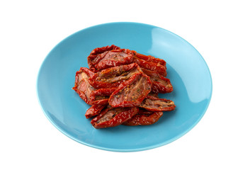 Dried tomatoes on a white background. Slices of dried tomatoes in oil on a plate.