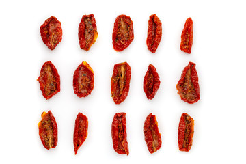 Dried tomatoes on a white background. Slices of dried tomatoes in oil close up. Top view.