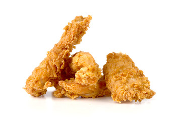 Fried chicken fillets on a white background. Fried chicken nuggets close-up.