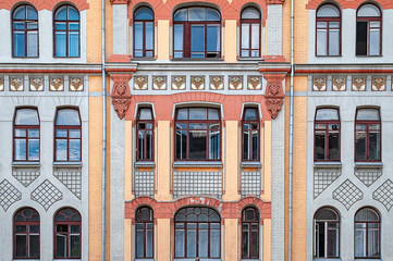Fototapeta na wymiar Many windows and a balcony on the facade of the old building.