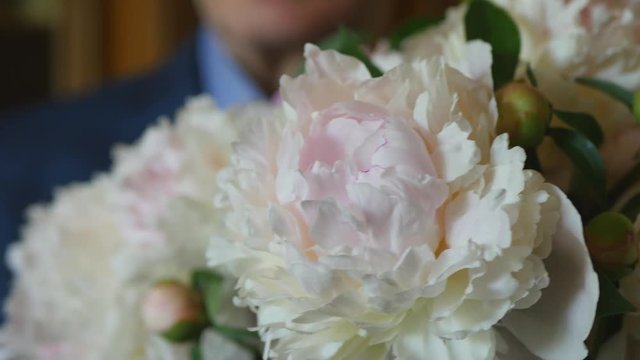 The Man In The Suit With Colorful Peonies Bouquet Slider Shot.