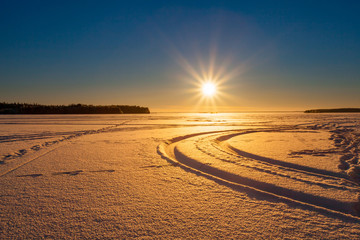 Fototapeta premium Winter landscape during sunset on frozen lake