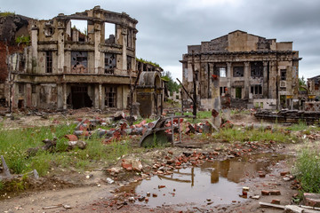 The ruins of the city. The remains of destroyed houses. Broken houses. Deserted ruins of the...