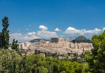 Acropolis and Lycabettus Hill framed by trees from the summit of Lycabettus hill