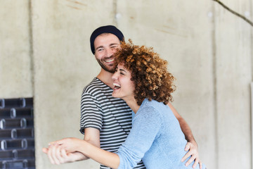 Laughing playful couple dancing