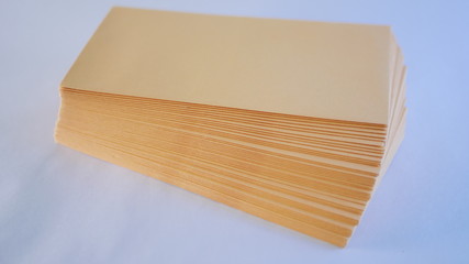 A neat stack of kraft cash envelopes spread on table for budgeting, personal finance, or business uses.