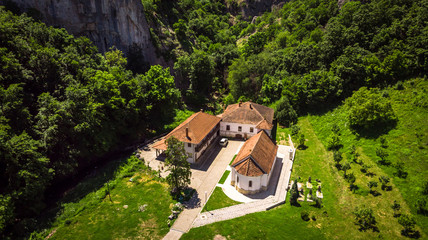 Small monastery Vratna in Serbia under the big stone, surrounded with forest