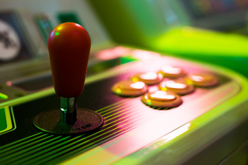 Detail on a red joystick of an old vintage arcade game