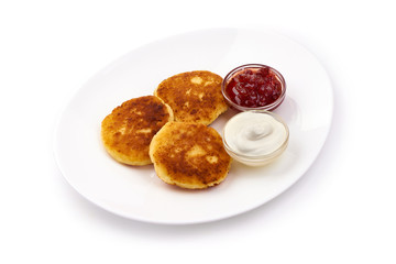 Cottage cheese pancakes, close-up, isolated on white background