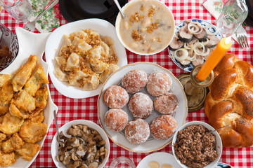 Traditional Christmas table in Ukraine. Twelve dishes: kutya, stewed fruit, dumplings with potatoes and cabbage, pickled mushrooms, donuts, garlic, fried and smoked fish, herring, gravy, beet salad