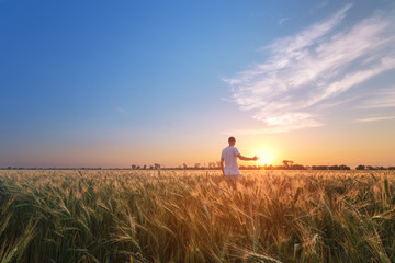 Fototapeta premium man in field at sunset / bright spring photo Ukraine