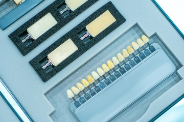 Production of dental veneers. Color scale for the selection of shades of veneers. The definition of the color of tooth enamel. Set of colors of dental implants.  Dentistry.
