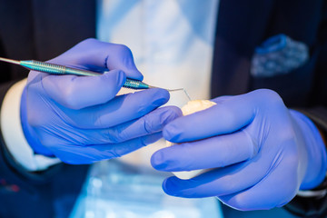 Dental modeling. Dental technician honing plaster model of the jaw. Individual dental prosthetics. Orthodontics. Dentistry.