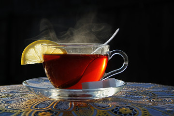 Hot tea with lemon and sugar on a black background - 271678425