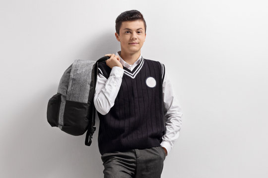 Male tenage student holding a backpack