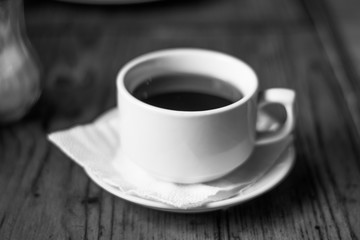 A cup of coffee tea in a cafe black and white photo