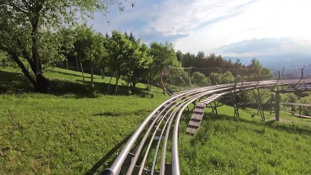 Driving the Alpine Coaster from the first person. Beautiful mountain surroundings and sunny weather.