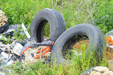 Abandoned old car tires in nature. Garbage dump in nature. Environmental pollution.