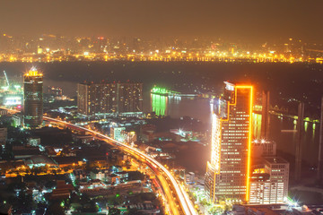 Fototapeta na wymiar Aerial view of Bangkok downtown buildings and Chao Phraya River at night.