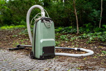 Old vacuum cleaner in outdoor environment