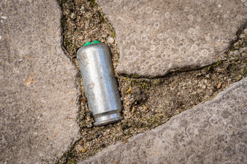 Closeup of Bullet casing lying on a road