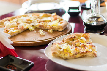 A slice of fresh pizza on a plate.
