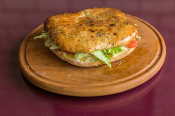 Panini, toasted bread with fresh vegetables and meat.