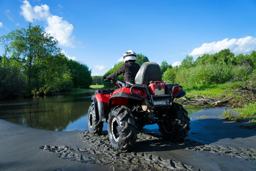 Outdoor activity. Quad bike rides. Extreme sport. Nature, forest, river.