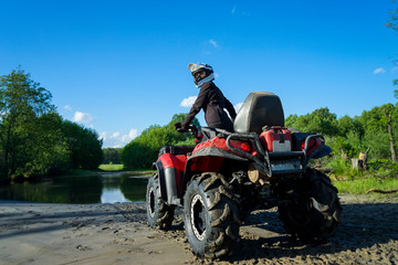 Fototapeta na wymiar Outdoor activity. Quad bike rides. Extreme sport. Nature, forest, river.