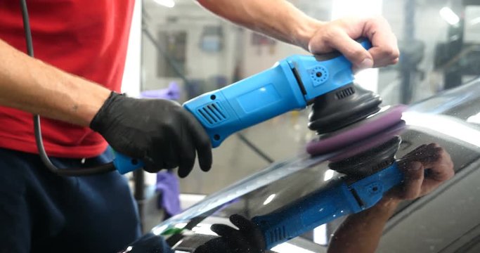 A professional bodywork and headlamp polishing worker will transport the car after painting or preparing for sale. Concept of: Freshen cars, Automotive center, Service, Professional.	