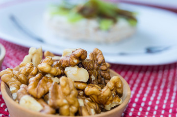  Nuts in pieces and background rice biscuit with kiwi.